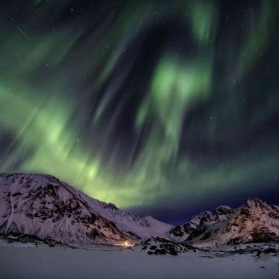 Northern Lights illuminating the mountains and fjords of Lofoten